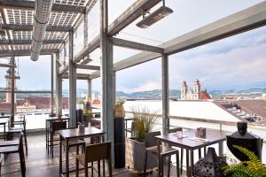 
a dining room with a balcony overlooking a city at Hotel Schwarzer Bär in Linz
