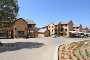a parking lot in front of a apartment complex at Kyalami Creek in Midrand