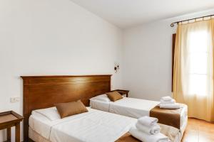 En eller flere senge i et værelse på Borgo Magliano Resort