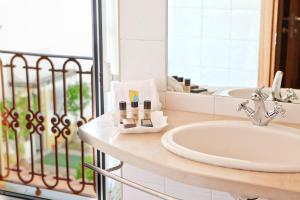 a bathroom with a sink and a mirror at Convento D'Alter Hotel in Alter do Chão