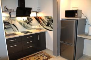 Kuchyňa alebo kuchynka v ubytovaní Apartament Perełka Przy Krupówkach
