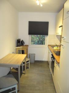 a kitchen with a table and a table and a window at Erlengrund 20 in Isenbüttel