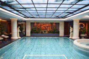 a large swimming pool in a large room at Xheko Imperial Luxury Boutique Hotel in Tirana