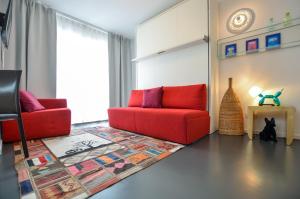 a living room with two red couches and a rug at K314 in Bonn