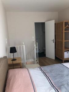 a bedroom with a bed and a room with a closet at Duplex centre ville 200m de la plage in Dinard