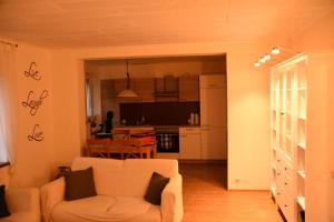 ザンクト・アンドレーアスベルクにあるClydeのリビングルーム(白いソファ付)、キッチンが備わります。