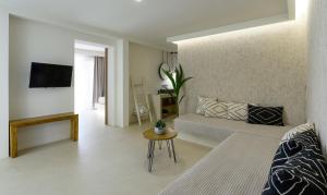 a living room with a couch and a table at Karidi Beach Boutique Suites in Vourvourou