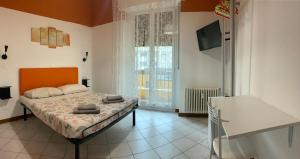a bedroom with a bed and a large window at marconi 22 rooms in Bologna