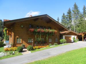 a house with flowers on the side of it at Appartement Hartl in Filzmoos