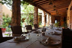 una mesa larga con platos y copas de vino. en Hotel Rural Cerro Principe en La Garrovilla