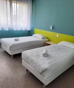 Postel nebo postele na pokoji v ubytování PARME ETAPE