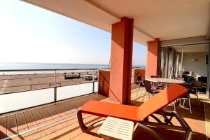 d'un balcon avec un banc et une vue sur la plage. dans l'établissement Magnifique appartement vue mer, à Valras-Plage