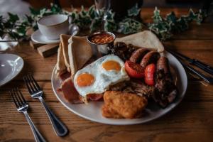 a plate of breakfast food with eggs and sausage at South Causey Inn in Stanley