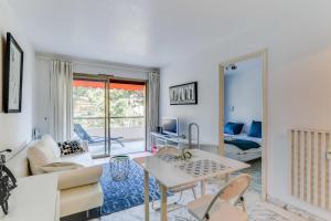 ein Wohnzimmer mit einem Sofa und einem Tisch in der Unterkunft IMMOGROOM- Open view terrace - Parking - Next CROISETTE in Cannes