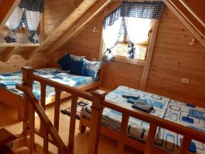 two beds in a room in a log cabin at BRVNARE STOJIĆ in Kokin Brod