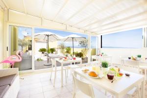 a dining room with a view of the ocean at A View on Cagliari in Cagliari