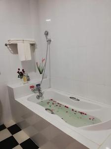 a bathroom with a bath tub with a sink at The Pegu Lodge in Bago
