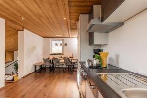 a kitchen and dining room with a dining table at Schlicki´s Appartement in Flachau
