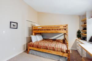 a bedroom with a bunk bed and a desk at Mountain Breeze in Breckenridge