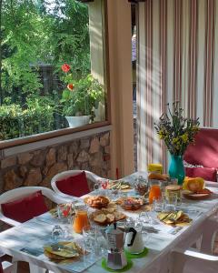 una mesa blanca con comida y zumo de naranja. en B&B Ca di me, en Premariacco