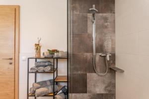 Un baño con ducha con puerta de cristal en Schlicki´s Appartement, en Flachau 29 fotos más