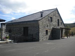 a large stone building with a black roof at Casa de Aldea Araceli in Berducedo