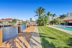 a wooden walkway next to a body of water with buildings at By the Sea Villa in Fort Lauderdale