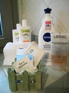 a bathroom counter with hygiene products on it at L'Adele Bed & Breakfast in Occimiano