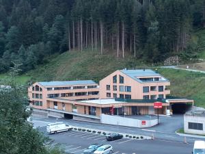 un edificio con aparcamiento frente a una montaña en Sellrain apartment, en Sellrain