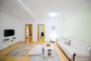 a living room with a white couch and a table at Village house Vrelo in Mandići