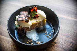 a piece of cake on a plate on a table at Kimpton Aertson Hotel by IHG in Nashville