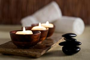 a group of candles on a table with a group of black stones at Kimpton Aertson Hotel, an IHG Hotel in Nashville