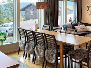 a dining room with a wooden table and chairs at 8 person holiday home in S LEN in Sälen