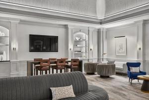 a living room filled with furniture and a large window at Kimpton Hotel Monaco Denver, an IHG Hotel in Denver