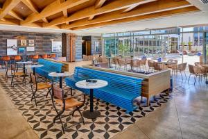 a restaurant with blue tables and chairs and windows at Hotel Indigo El Paso Downtown by IHG in El Paso +82 photos