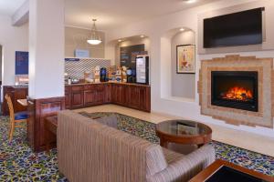 a lobby with a fireplace in a store at Holiday Inn Express & Suites Alamosa, an IHG Hotel in Alamosa