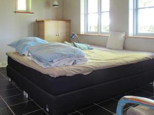 Säng eller sängar i ett rum på Holiday home Dannemare XVII