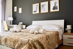 a bedroom with a bed with pillows on it at Le Muse in Reggio di Calabria