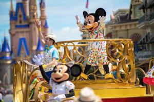 a group of people riding on a disney parade in the magic kingdom at Holiday Inn Express & Suites S Lake Buena Vista by IHG in Kissimmee