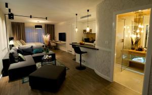 a living room with a couch and a table at Apartman My Story in Osijek