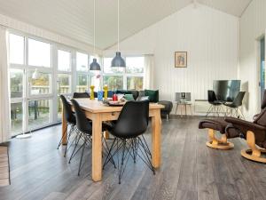 een eetkamer met een houten tafel en stoelen bij 8 person holiday home in Ringk bing in Søndervig