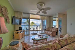 a living room with a couch and a tv at Beachfront Kihei Sanctuary with Lanai and Ocean Views! in Kihei