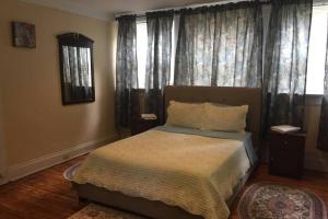 a bedroom with a bed with a large window at 3 Bedroom Apartment steps to Clifton, Zoo, UC, Hospitals in Cincinnati