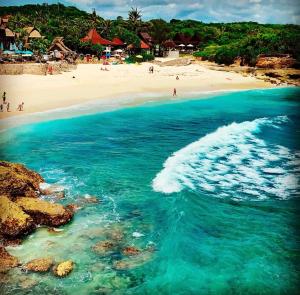 an aerial view of a beach with people on it at D'byas Dream Beach Club and Villa in Nusa Lembongan