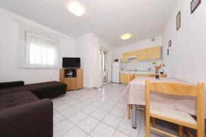 a living room with a couch and a table at Apartment Alexa in Turanj