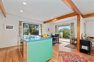 a kitchen with a blue counter top in a room at Taste Of Paradise with WiFi!- Mangawhai Heads Home in Mangawhai