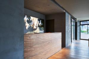 a room with a counter with a painting on the wall at THE REIGN HOTEL KYOTO in Kyoto