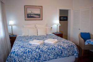 a bedroom with a bed with two towels on it at Boathouse Bunbury Bed & Breakfast in Bunbury