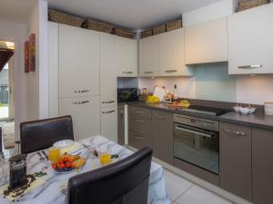 a kitchen with a table with a bowl of fruit on it at Modern 2 Bed House with Parking and Garden in Nottingham