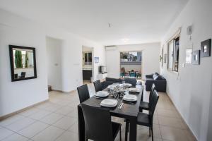 a dining room and living room with a table and chairs at Palm Villa 36 in Protaras